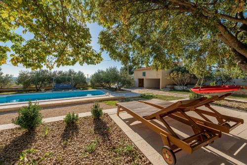 a picnic table next to a swimming pool at Holiday home Apios in Benkovac