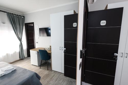 a bedroom with a black door and a desk at Seven Kings Relais in Rome