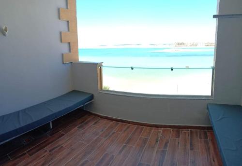 a room with a window with a view of the ocean at L’amour Hotel apartment in Marsa Matruh
