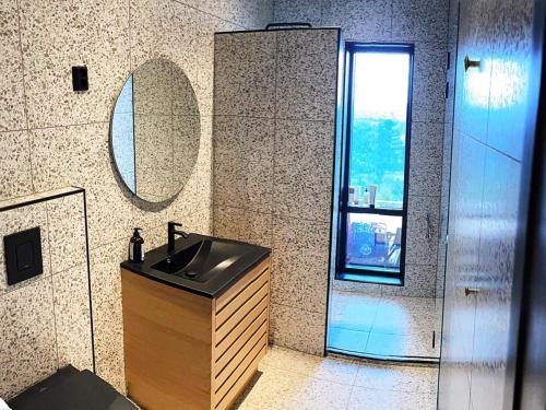 a bathroom with a sink and a mirror at Holiday home Drangedal in Drangedal
