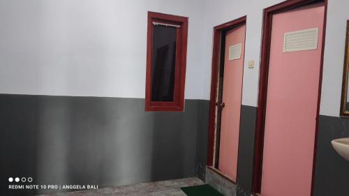 a bathroom with a sink and a mirror at Tengger Indah Bromo by ABM in Bromo