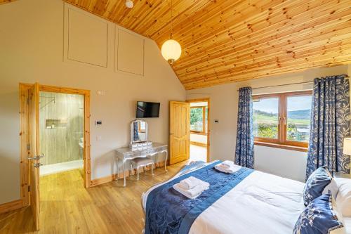 a bedroom with a bed and a wooden ceiling at Roe Deer Lodge with Hot Tub in Cray