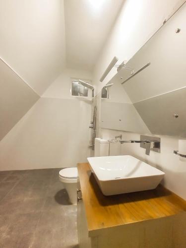 a bathroom with a sink and a toilet at Once in Ella in Ella