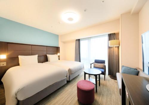 Postel nebo postele na pokoji v ubytování Richmond Hotel Namba Daikokucho