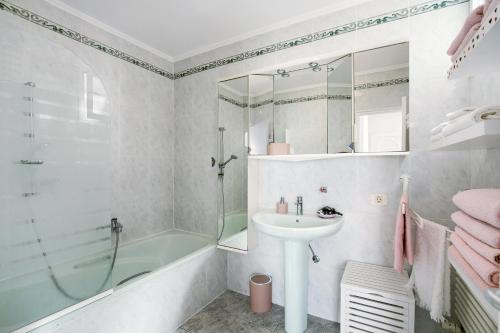 a bathroom with a shower and a sink and a tub at Casa Paraíso in Puerto de la Cruz