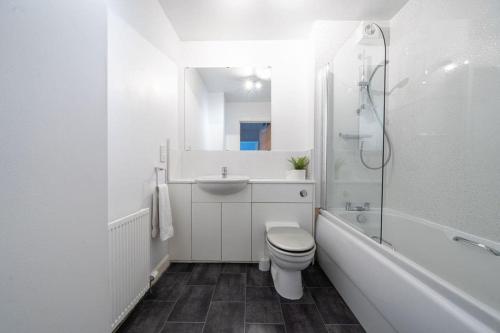 a white bathroom with a toilet and a sink at Hope House - 2 bedroom flat in Aberdeen