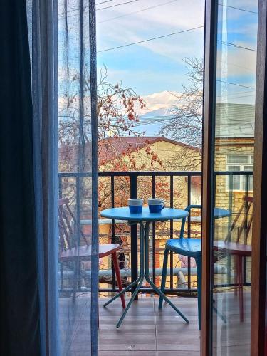 a table and chairs on a balcony with a view at Hestia - Hotel, Wine and View in Tʼelavi