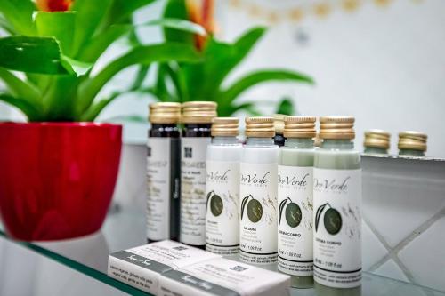 a group of four bottles of hair oil on a table with a plant at Residenza Giotto in Florence