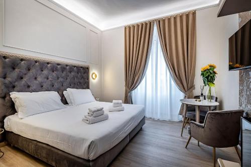 a hotel room with a large bed and a table at Residenza Giotto in Florence