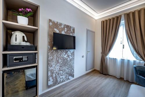 a living room with a tv on a wall at Residenza Giotto in Florence