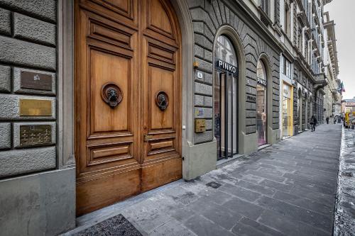 a wooden door on the side of a building at Residenza Giotto in Florence
