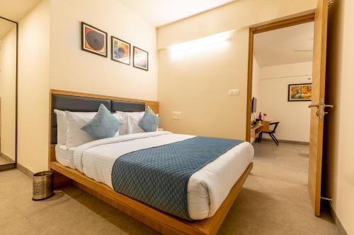 a bedroom with a large bed in a room at Iris Magnum - APart Hotel in Bangalore