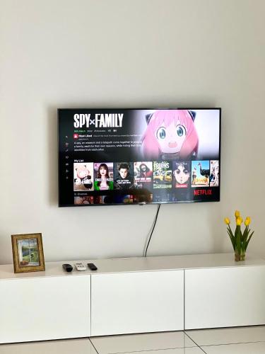 a flat screen tv hanging on a wall at Ipoh Peaceful Onsen studio Lost World Tambun in Tambun