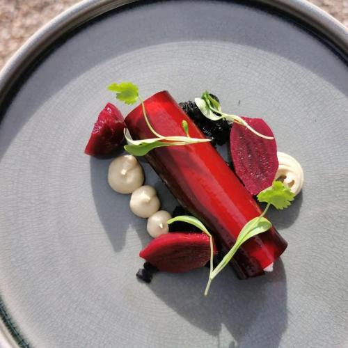 a plate of food with vegetables on a table at Blakeney House in Blakeney