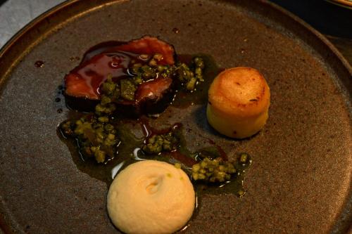 a plate of food with meat and vegetables on it at Blakeney House in Blakeney