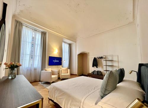 a bedroom with a bed and a living room at The Seven Suites in Genova