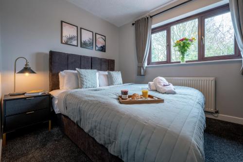 a bedroom with a bed with a tray of food on it at Yew Tree House Contractor / Family home Free Netflix Fast WiFi near Dudley/Birmingham in Old Hill
