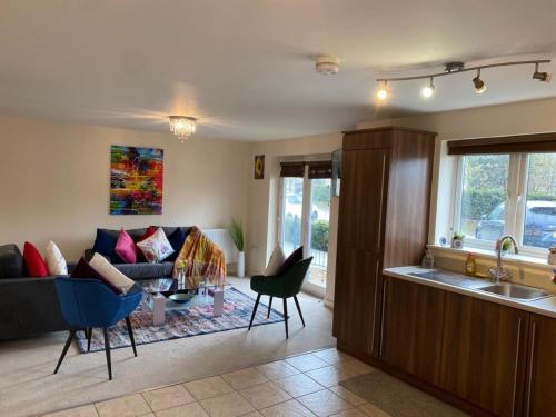 a living room with a couch and a table at Exquisite Modern Homely 2 Bed Apartment with On-street Parking, Super Fast WIFI & 5 mins drive to Science & Business Parks in Cambridge