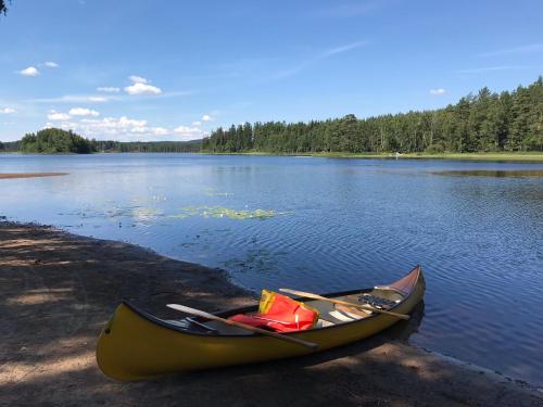 a canoe sitting on the shore of a lake at Views of Isaberg and fitting two families! in Hestra