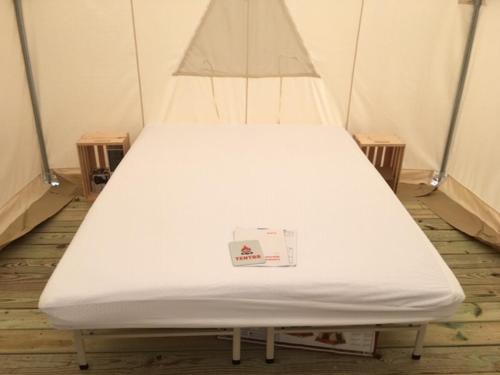 a bed in a room with a white mattress at Tentrr Signature Site - Maramec Spring Park McDole's Meadow in Saint James