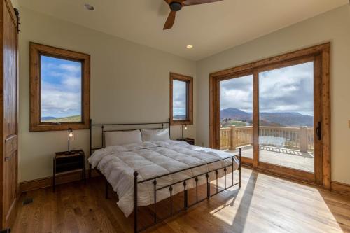 een slaapkamer met een bed en een groot raam bij All Around Views at Monteagle in Banner Elk