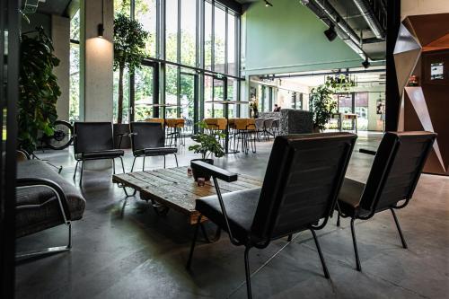 a group of chairs and a table in a room at Hotel Valkenburg by Mercure - Next to Shimano Experience Center in Valkenburg