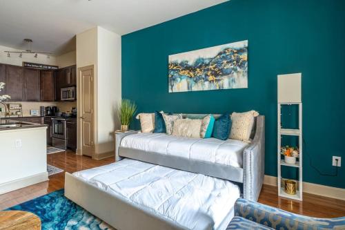 a living room with a couch and a blue wall at Call it Comfy in Houston