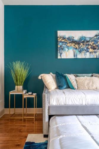 a living room with a couch and a blue wall at Call it Comfy in Houston