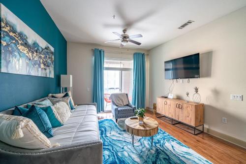 a living room with a couch and a flat screen tv at Call it Comfy in Houston