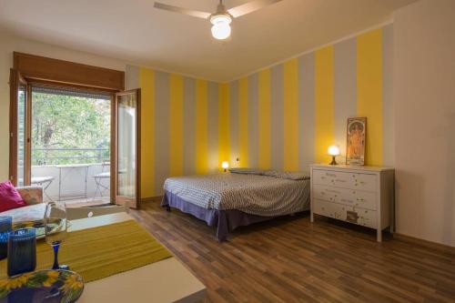a bedroom with a bed and a couch and a window at Sunny Open Space in Pompei