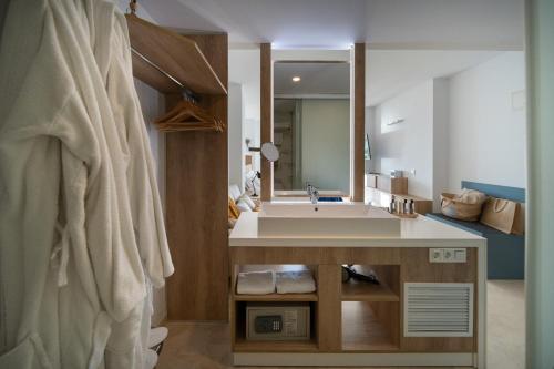 a bathroom with a sink and a large mirror at La Sort Boutique Hotel in Moraira