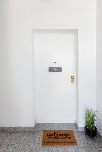 a door with a welcome mat in front of it at Zadar Sunset Penthouse with spectacular view and jacuzzi in Zadar