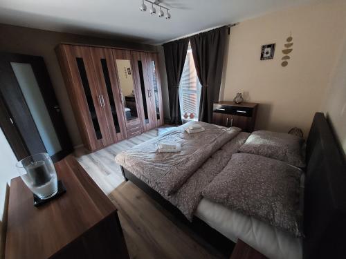 a bedroom with a large bed and a window at Frašták apartment in Hlohovec