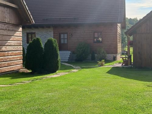 a house with a lawn in front of it at Chalupy v Podkrkonoší- Chalupa Oto, Chalupa Prade in Hostinné