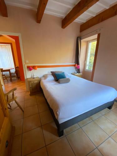 a bedroom with a large bed in a room at Logis Hôtel Restaurant Le Domaine de l'Eau Vive in Largentière