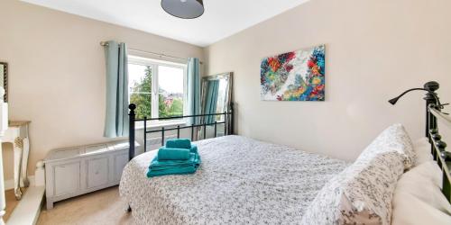 a bedroom with a bed with a blue towel on it at Finest Retreats - Tyg Cottage near Masham, Fountains Abbey & Brimham Rocks in Ripon