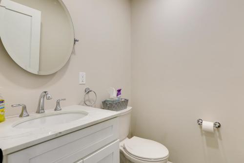 a bathroom with a sink and a toilet and a mirror at Renovated Family Home on Providence River! in Riverside