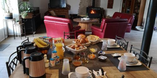 a table with food on it in a living room at la Ferme du Grand Bois in Mouterre-Silly