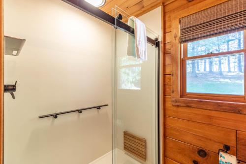 a glass shower in a bathroom with a window at South Fork Cabin in Fleetwood