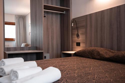 Postel nebo postele na pokoji v ubytování Hotel Ciclamino