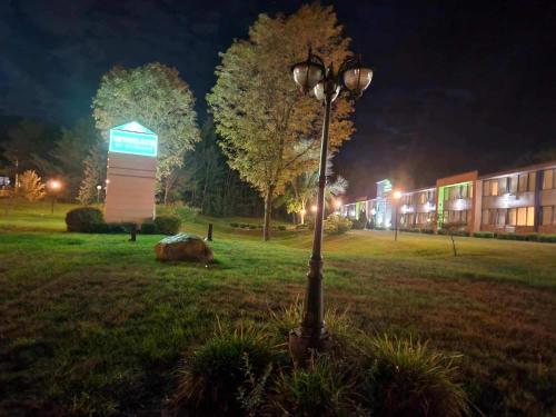 a street light in a field next to a building at Wingate by Wyndham Lake George in Lake George