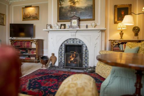 a living room with a fireplace and a couch at Upper Helmsley Hall 20 in Upper Helmsley