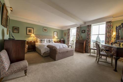 a bedroom with a bed and a desk and a chair at Upper Helmsley Hall 20 in Upper Helmsley