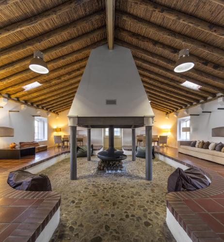 a large room with a large ceiling and a pool at Parque de Natureza de Noudar in Barrancos
