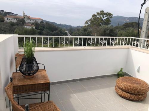 a balcony with a table and chairs and a view at Lovers House in Setúbal