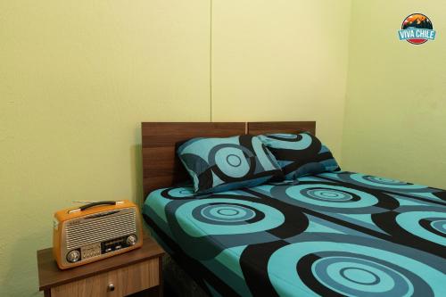 a bedroom with a bed and an old radio at Viva Chile Santiago Centro in Santiago