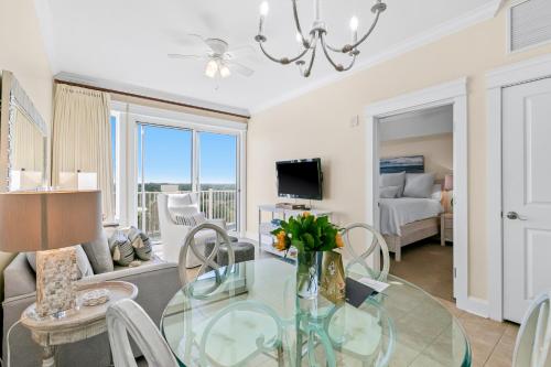 a dining room and living room with a glass table at The Grand 2803 in Destin