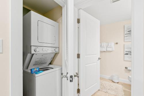 a bathroom with a washer and dryer at The Grand 2803 in Destin