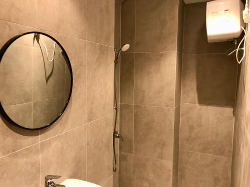 a bathroom with a mirror and a shower at ONE BEDROOM APARTMENT POLLUX MEISTERSTADT BATAM CENTRE in Batam Center