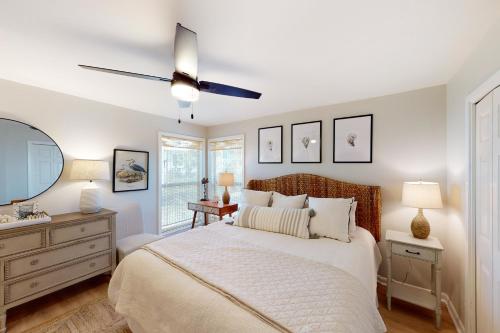 a bedroom with a bed and a ceiling fan at Cotton Bayou B1 in Orange Beach